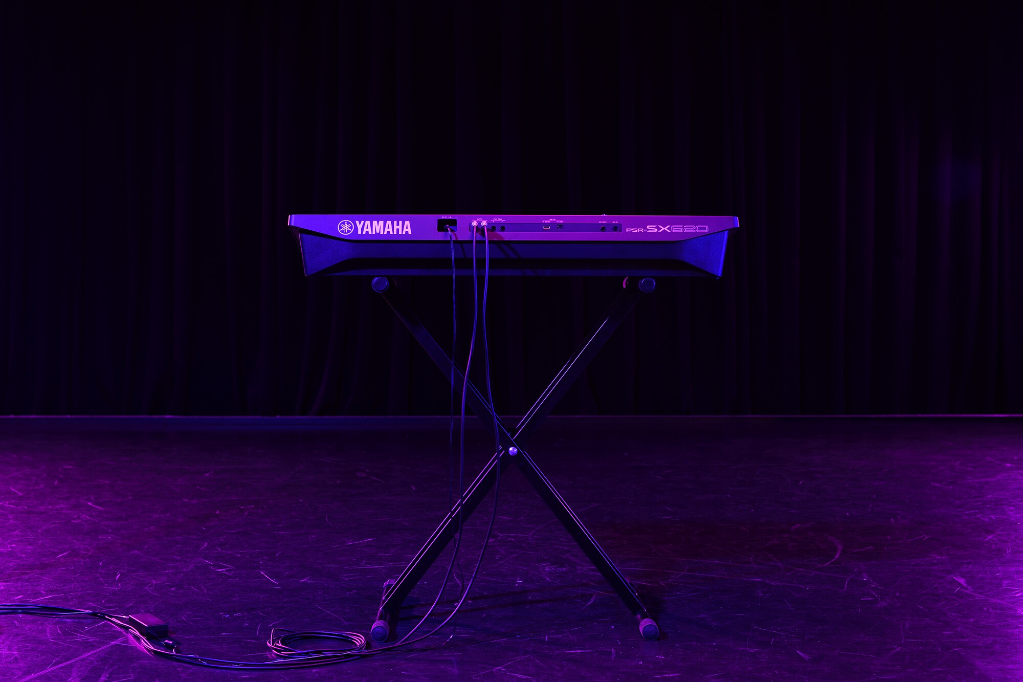 A keyboard on a stand under stage lighting