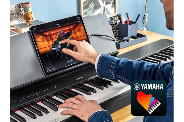 The Yamaha “Smart Pianist” app icon, together with a tablet placed on the m ature imageusic stand of the P-225