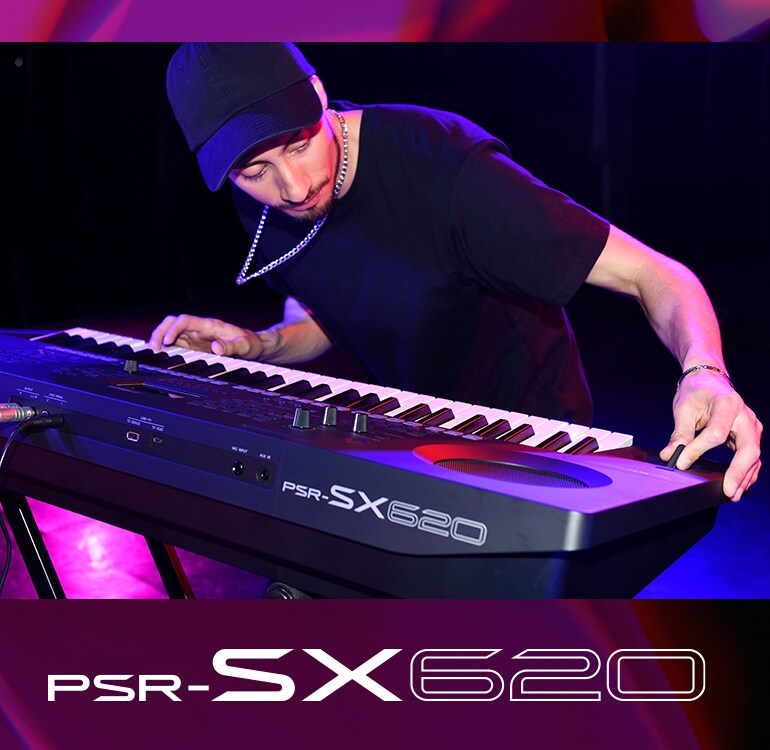 Performer playing a PSR-SX620 keyboard on stage.