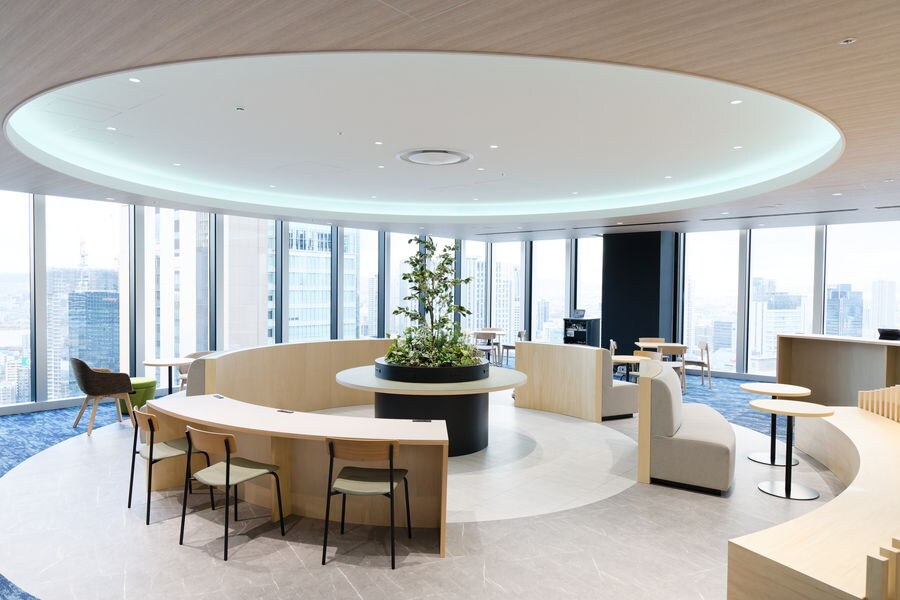 Open gathering space with a central round table for collaboration
