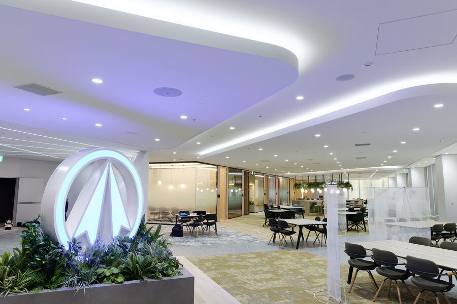 Entrance space with decorative ceiling lighting and central signage display