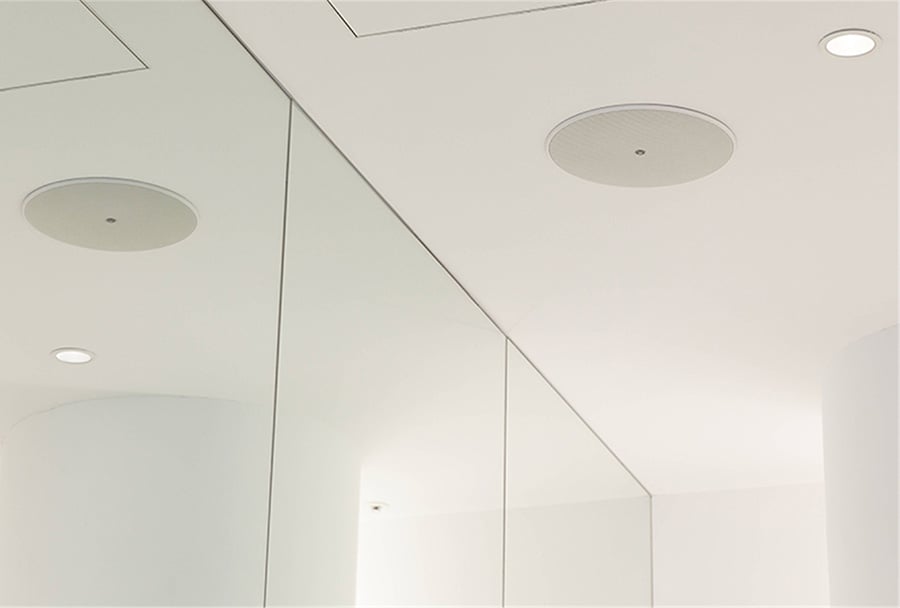 An in-ceiling speaker seamlessly installed for high-quality sound distribution.